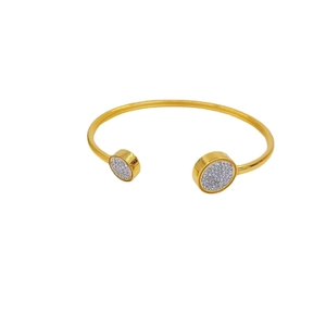 Adjustable gold plated cuff bracelet featuring round ends with micro-paved white zircons