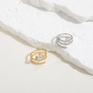Three-row spiral nail ring set in gold and silver finish with pavé set cubic zirconia