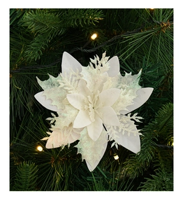 Detail of white artificial poinsettia flower with glitter on a green Christmas tree