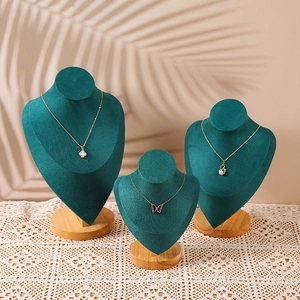 Three sizes of dark green velvet necklace busts with premium solid wood bases for jewelry