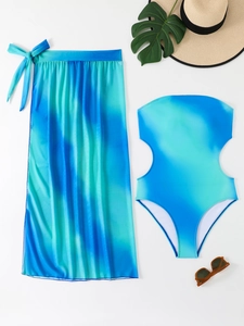 Flat lay of gradient blue swimsuit set with side cutouts and a matching chiffon sarong