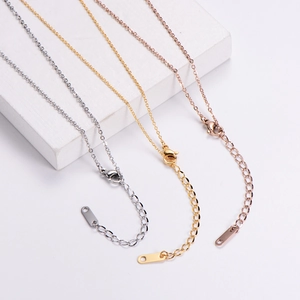 Close-up of adjustable extension chains with lobster clasps in gold, silver and rose gold