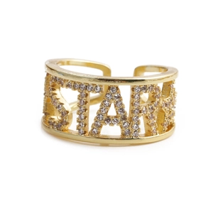 Adjustable golden letter STARK ring with sparkling cubic zirconia crystals on white background