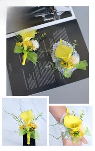 Detailed set of yellow calla lily boutonniere and wrist corsage for wedding guests