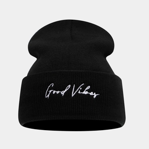 Close-up of black knit beanie featuring white Good Vibes embroidery on the cuff