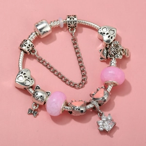 Detail of DIY cat charm bracelet with pink glass beads and silver paw print pendants