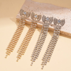 Eleganti orecchini a fiocco oro e argento con nappine di strass brillanti in coppia