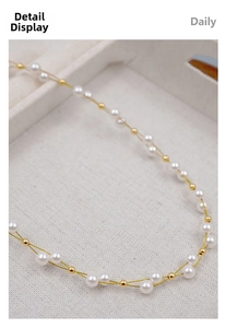 Detail of handmade woven necklace featuring white pearls and small gold beads