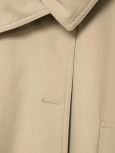 Macro shot of khaki trench coat collar with precise stitching and high-density twill texture