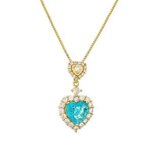 Double layered gold heart necklace with blue and clear pavé crystals on white background