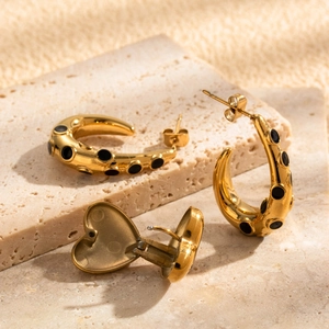 French style gold C-shape earrings with black micro-inlay circles and heart detail