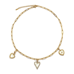 Detail of paperclip chain necklace featuring shell heart pendants and cubic zirconia accents