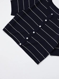 Detail of dark blue striped knit top with pearl buttons and fine ribbed textures