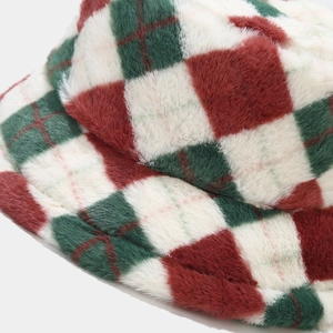 Close-up of fluffy red and green plaid faux fur texture on warm bucket hat fabric