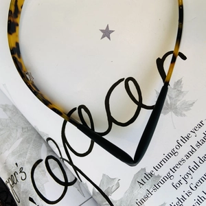 Close-up of slim tortoiseshell headband with anti-slip tips on a vintage magazine page
