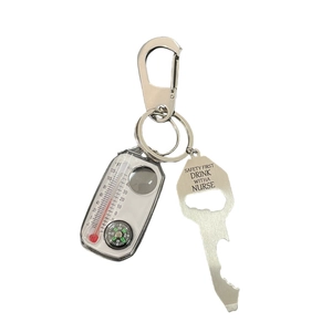 Metal keychain with bottle opener tool, thermometer, and compass on white background
