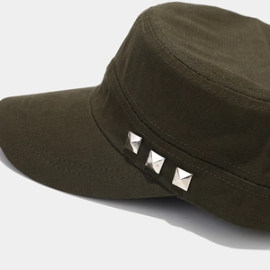 Detail view of military flat top cap featuring silver metal rivets on olive cotton fabric