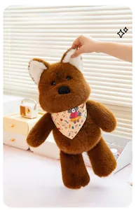 Detail of soft plush brown bear toy wearing a yellow cartoon patterned neck scarf