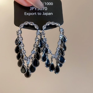 Detailed macro view of vintage zircon tassel earrings with sparkling teardrop gemstones