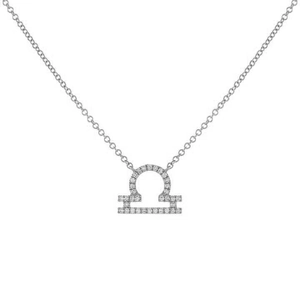 Detail of silver Libra necklace pendant with sparkling zircon stones on white background