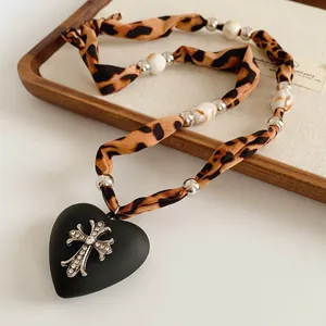 Vintage cross necklace with leopard print fabric and resin heart pendant