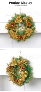 Close-up of artificial pine wreath with golden flowers, cones and Merry Christmas sign