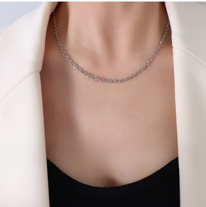 Detailed view of 3mm stainless steel faceted chain worn on a stylish female model