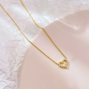 Elegant hollow heart necklace with zircon inlay on a golden chain for women