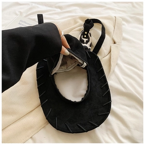 Detail view of black suede cowboy hat backpack interior with zipper and lining