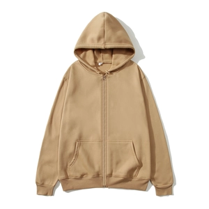 Detail of khaki zip-up hoodie featuring ribbed cuffs and kangaroo pockets on fabric