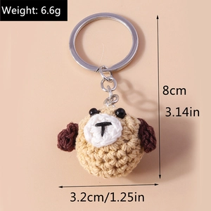 Macro detail of hand-crocheted dog keychain with silver metal ring and size markings