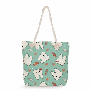 Mint green canvas tote bag with cartoon tooth patterns and white cotton rope handles