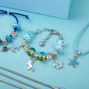 Macro view of blue unicorn and castle charms for DIY jewelry making sets for kids