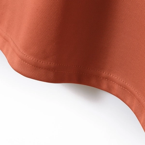 Close-up of rust orange polo shirt featuring breathable mesh texture and reinforced double-stitching