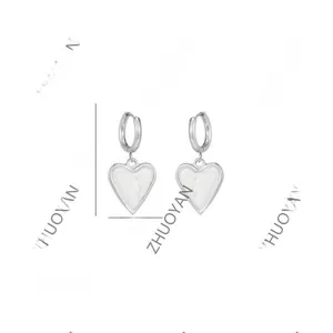 Detail view of heart drop earrings in silver with dimensions 3.6cm by 1.7cm and 9g weight