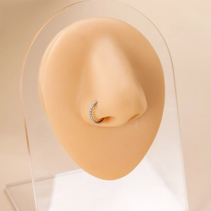 Silver G23 titanium nose ring with pave cubic zirconia on a silicone model display