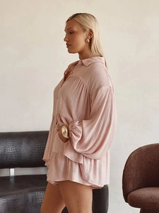 Detail of light pink lantern sleeves and tiered ruffle hem on this leisure shirt set