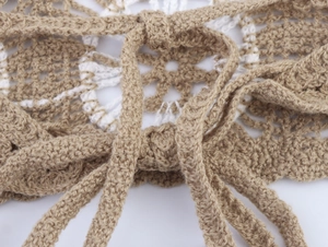 Detailed macro view of the khaki crochet halter top showing handmade knitted patterns