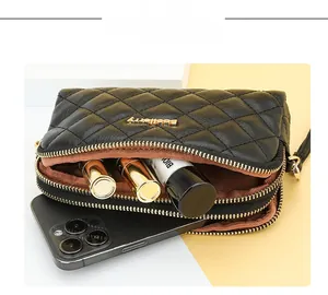 Detail view of large capacity quilted wallet with phone and lipstick storage compartments