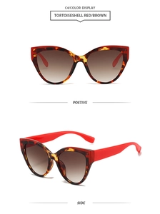 Detail of tortoiseshell cat eye sunglasses with red temples and gradient brown lenses