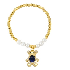 Golden beaded bracelet with pearls and a blue heart crystal bear pendant for women