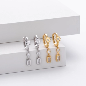 Detail view of S925 silver star earrings with micro-pave cubic zirconia on white steps