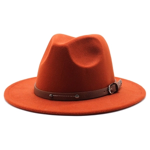 Detail of rust red felt fedora hat featuring a brown leather band and silver metal buckle