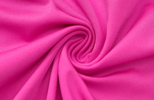 Detailed view of magenta knitted fabric texture with central spiral pleats and soft drape