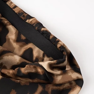 Women's leopard print satin fishtail skirt featuring a wide black elastic waistband