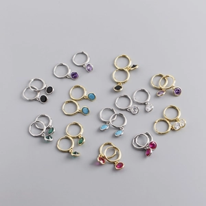 Macro view of S925 sterling silver huggie earrings with colorful round zircon charms
