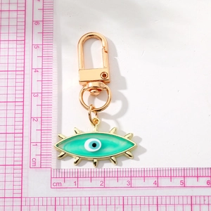 Gold metal keychain with turquoise enamel evil eye pendant and measurement scale