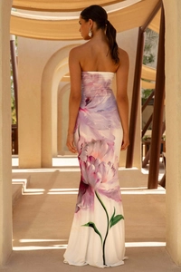 Close-up detail of the elegant purple floral print on the white backless maxi dress