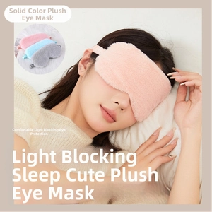 Close-up of soft plush sleep mask with elastic strap shown in pink, blue and grey