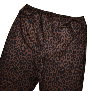 Close-up of leopard print elastic waist pants with brown and black animal pattern details